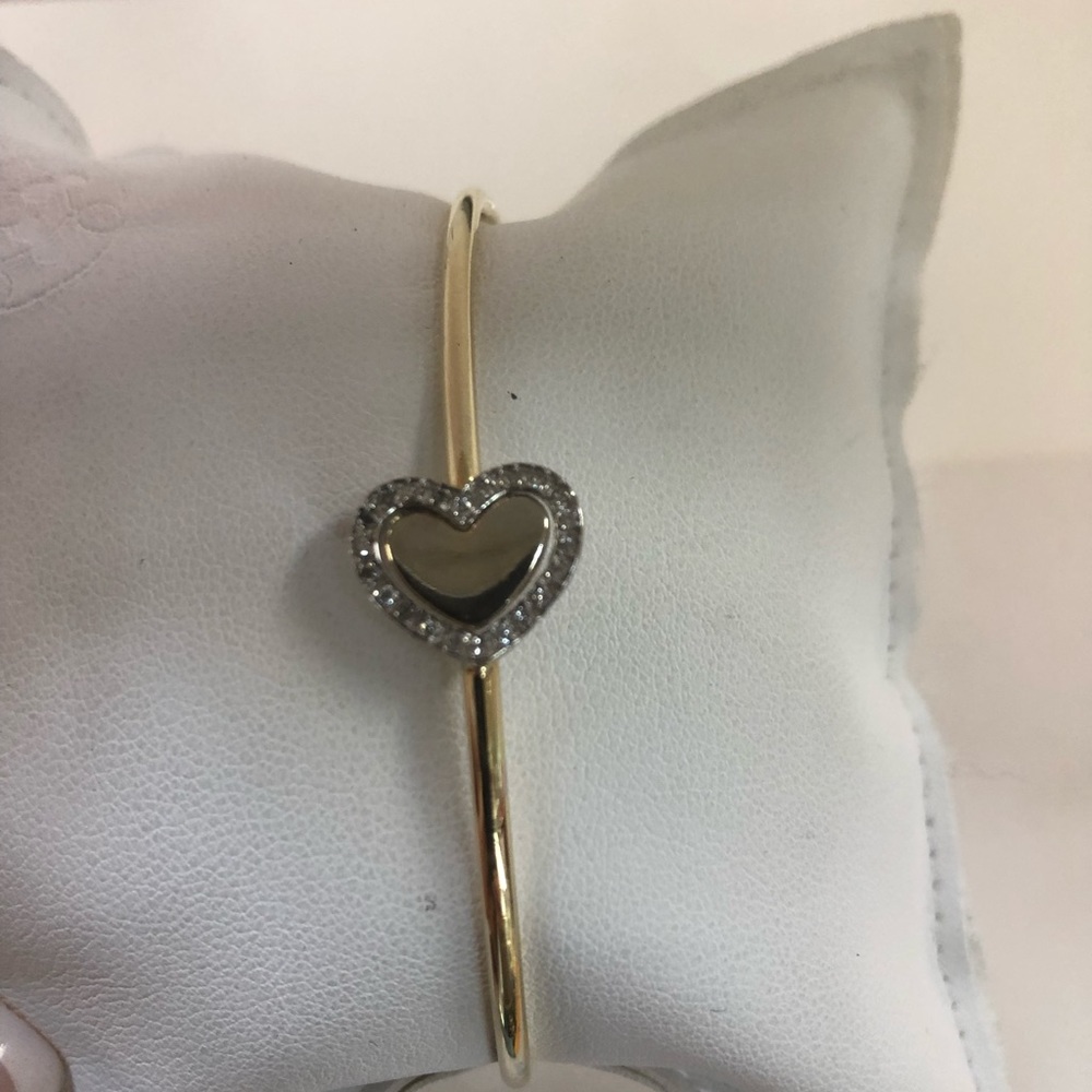 14kt y/g approx .22cts/100 diamonds . Bangle brac